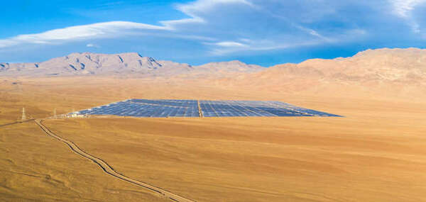 Aerial drone view of a Solar Energy Photovoltaic Power Plant over Atacama desert sands, Chile. Sustainability and green energy from the sun with Solar Energy in the driest desert in the world: Atacama -