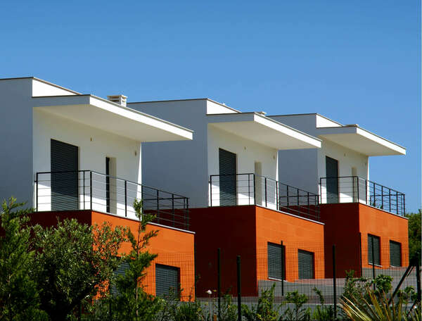 Facades of a houses condominium in a sunny day