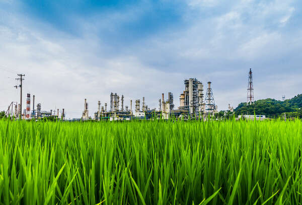  green lawn on petroleum infrastructure background