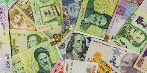 Banknotes of different countries spread around the banknote 100 US dollars