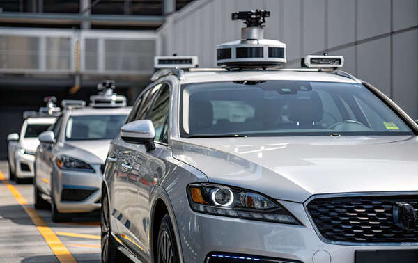 Self driving cars equipped with advanced sensors and cameras, showcasing modern autonomous vehicle technology