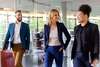 3 people walking together in an office
